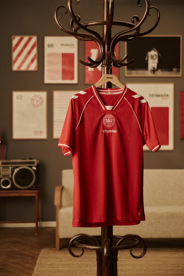 Red DUB jersey on a coat rack with posters on the wall in the background